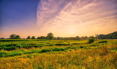 Sunset over the meadows of the pastoral landscape of Noord-Brabant, The Netherlands.