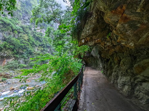 Taroko, Taiwan - 11.26.2022: Empty Shakadang Trail along cliffs and trees with Liwu River on the side in a mist during the pandemic before 403 earthquake on a rainy day