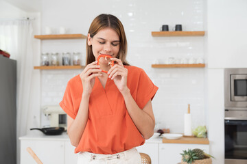 Young woman holding salad in kitchen room at home - Powered by Adobe