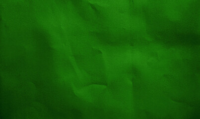close up crumpled dark green kraft paper background showing crease texture with blank space for design. flat crumpled cardboard green paper with grain texture.