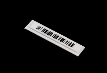 A magnetic anti-theft barcode label on a black background
