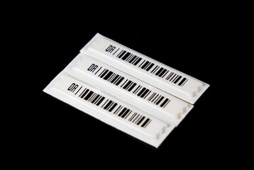 Labels with anti-theft barcodes on a black background