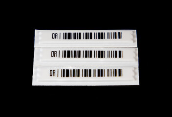 Labels with anti-theft barcodes on a black background