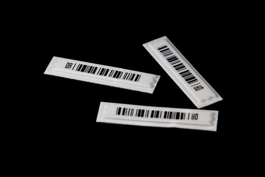 Labels with anti-theft barcodes on a black background