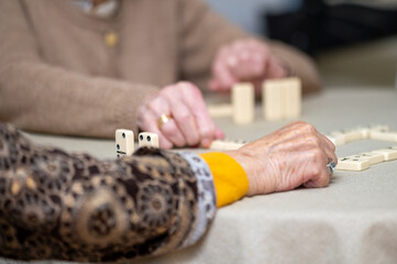 Close up of a group of elderly woman playing Domino. High Quality photography