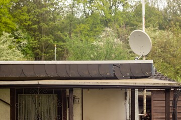 Satellite antenna on the roof of a garden shed