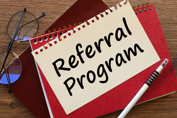 REFERRAL PROGRAM . Business concept. text on wooden block on chart background , business concept