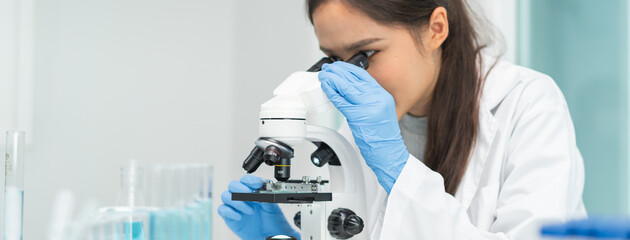 researcher using microscope analyse cell in medical lab.