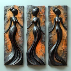 Fotobehang Three abstract wooden sculptures on panels depicting stylized female figures with elongated forms © InkCrafts