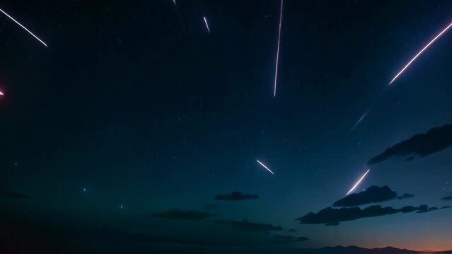 Video animation of  night sky adorned with several bright meteor trails. Clouds hug the horizon, creating a gradient of blue to dark colors in the sky.
