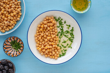 Chickpeas served with olive oil and chopped herbs.