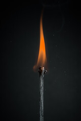 burning match on black background