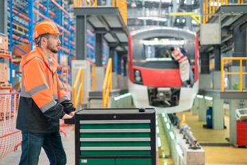 Railway Worker with Toolbox in Train Depot