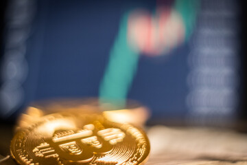 bitcoin close up coin crypto with stock market graph on background blurred on line trading 