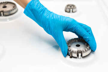 housewife washes a stove on a gas stove.