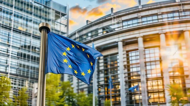 Rear view of the european parliament building in front of the official flag of the european union
