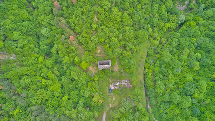 An unfinished abandoned entrance to a tunnel in the forests amidst the mountains. An incomplete...