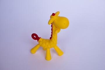 Rubber giraffe toy for baby. Giraffe shaped baby gum reflexology tool with white isolated object.