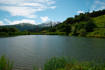 Beautiful mountain landscape in early spring. Cold blue lake.