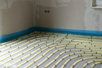 Underfloor heating system installation. Water floor heating system indoor