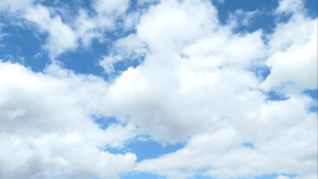 time lapse of big white clouds in a blue sky. Cumulonimbus passing in a sunny sky.