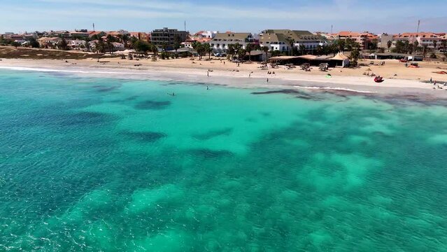 Flying over the beach of Santa Maria, Sal, Cape Verden. A beach bar centered

