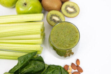 Healthy Vegetable Fruit Nut Green Smoothie in a Glass on a White Background.