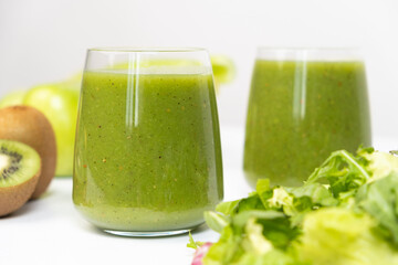 Healthy vegetable smoothie in glasses on white background.