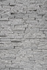 Gray wall of rough brick. Abstract construction background.