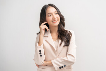 Smiling positive, attractive asian young woman in beige suit formal dress, pointing finger away....