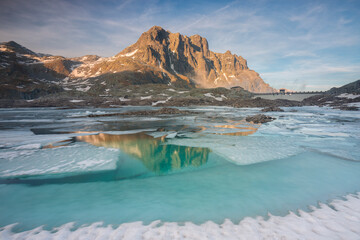 Frozen Vacca lake at sunset during spring season, Adamello park, Lombardy, Italy.	