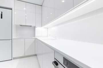 Modern snow white kitchen interior with acrylic countertop