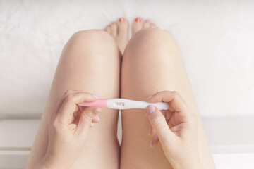 Woman holding in hands pregnancy test.