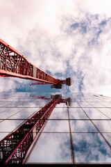 Red crane reflected on glass building 