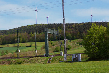 An image of a railway in Germany with wind turbines in the background.