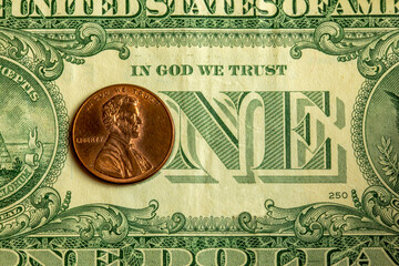 Detail of a one dollar bill with a Abraham Lincoln coin over the 