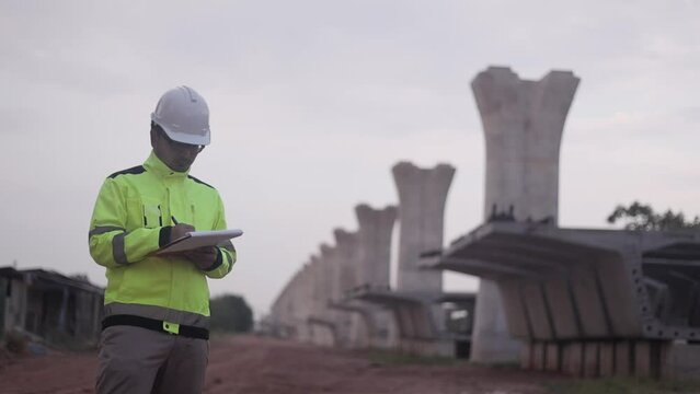 Asian engineer working at site of a large building project,Thailand people,Work overtime at construction site