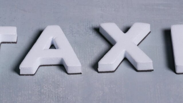 Taxes 3d letters close up light blue background