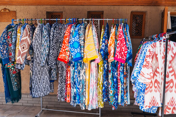 traditional Arabic dresses and female clothes with a bright colorful pattern at oriental bazaar in...
