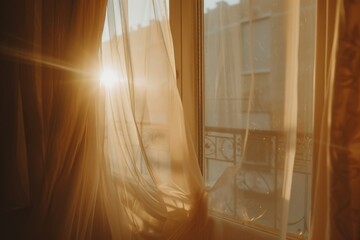 A window with a curtain that is open and letting in the sun