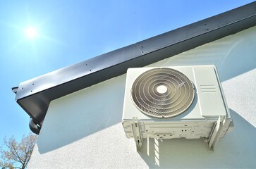 air conditioner under the roof with blue sky and sun best or business