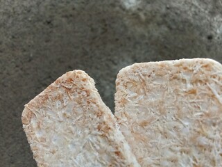 Sagon is a dry cake made from processed glutinous rice flour mixed with coconut. cement surface background.