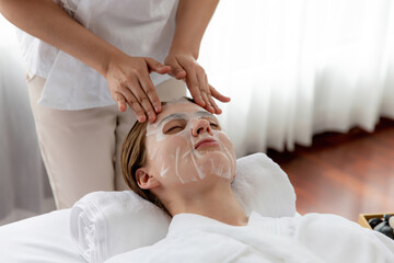 Serene modern daylight ambiance of spa salon, woman customer indulges in rejuvenating with facial...