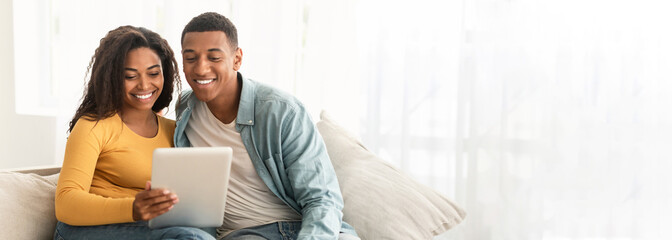 Couple with tablet enjoying time together at home