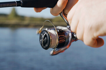 Person Holding Fishing Rod and Reel