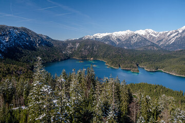 Fototapeta na wymiar lake in the snow mountainous region near the Alps in early spring 