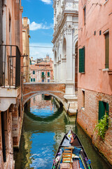 View of Rio della Frescada with Ponte della Scuola Bridge and gondola, a characteristic Venice...