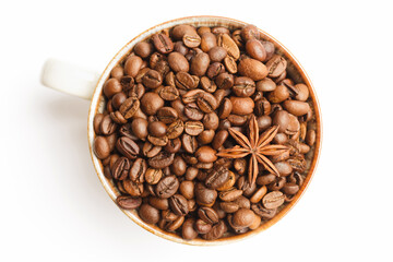 Cup with coffee beans and spices on white background. Top view