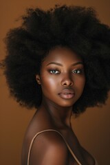 Fototapeta premium Natural hair, beauty, and black woman in studio portrait with little makeup for dermatology, salon, and hairdresser. African afro model youth face, headshot, and hair growth
