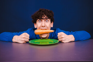 Funny young guy on a diet. A man posing in the studio.